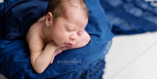 newborn boy in blue bucket in kingston portrait studio