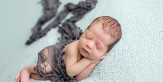 newborn boy on blue blanket photography