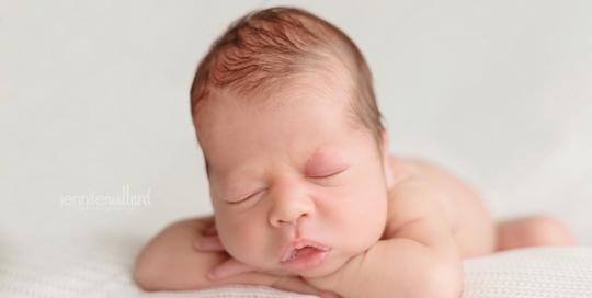 newborn boy on white blanket in studio in kingston ontario