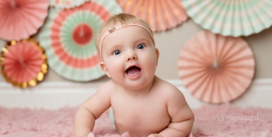 baby girl portrait in studio on pink rug