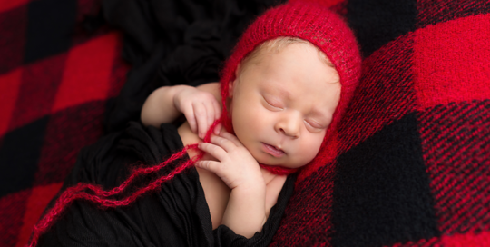 newborn-portrait-red-black-plaid-blanket-red-hat-black-wrap-kingston-portrait-studio