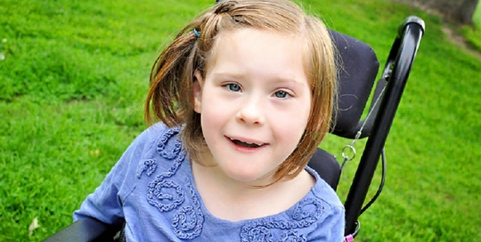 little girl in wheelchair in park by kingston ontario photographer