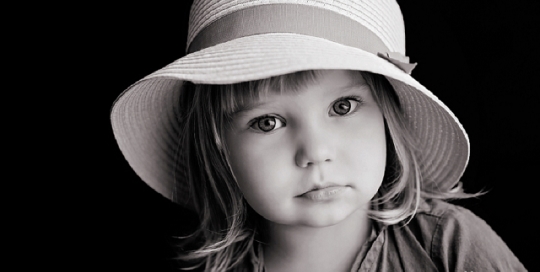 little girl in hat in black and white in kingston portrait studio