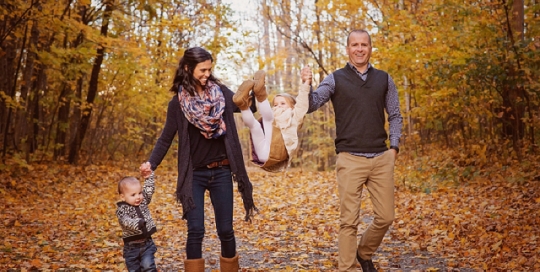 family swinging kid in air