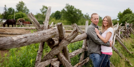 couple picture on farm against rail fence