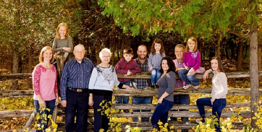 family portrait on fence rails on farm