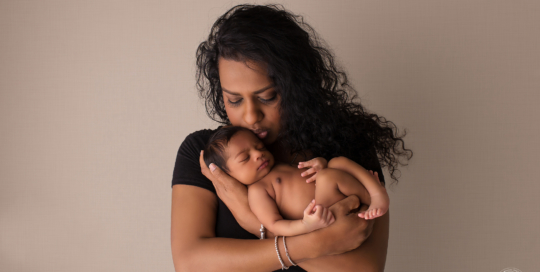 African American mother with newborn in her arms