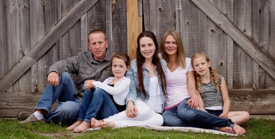 family in front of barn