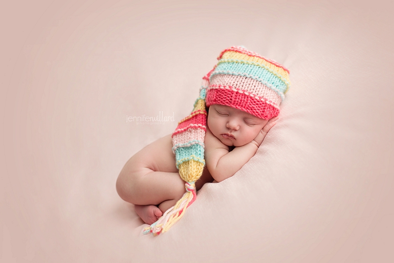 newborn baby with multi coloured hat