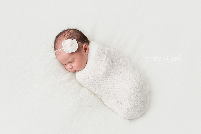 baby wrapped in white