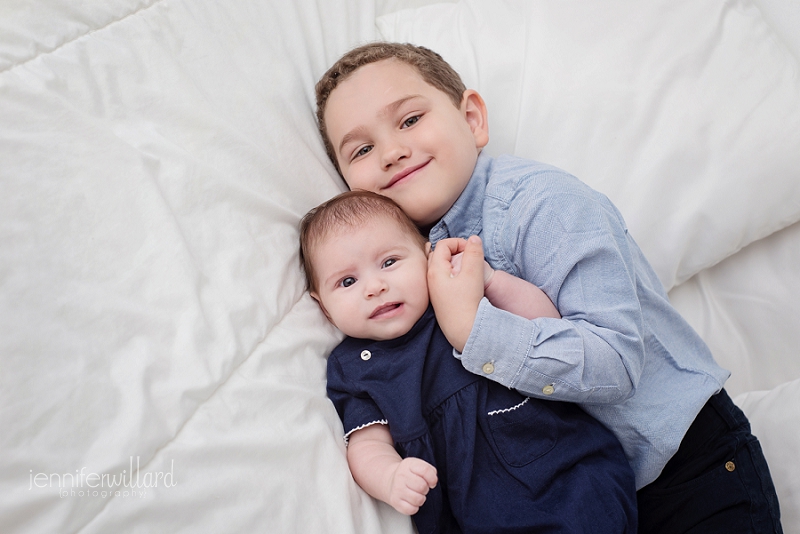 sibling portrait on bed