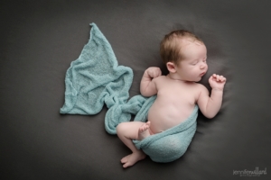 newborn pose on blanket