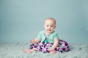 baby-girl-sitting-on-blue-rug-kingston-ontario-studio