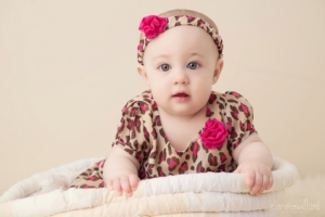 baby-girl-basket-animal-print-dress-cream-background-kingston-studio