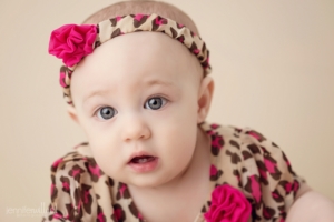 baby-girl-6-month-old-milestone-photography-animal-print-dress-cream-backdrop