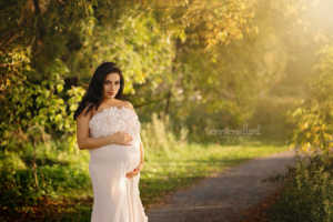 pregnant mom in peach fabric on trail in kingston ontario by jennifer willard photography