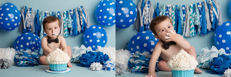 first-birthday-cake-smash-portraits-blue-backdrop-balloons-banners-pom-poms