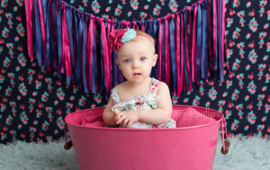 baby-vibrant-colour-portrait-girl-pink-bucket-blue-rug-backdrop-kingston-ontario-portrait-studio