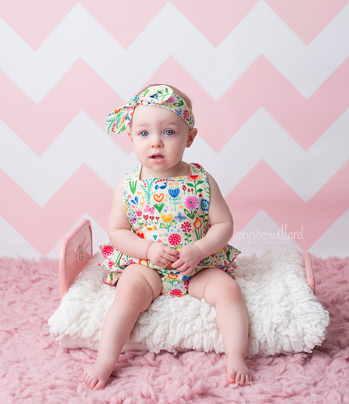 pink-chevron-backdrop-baby-girl-romper-headband-vintage-doll-bed-first-year-portrait-vibrant-baby-kingston-ontario