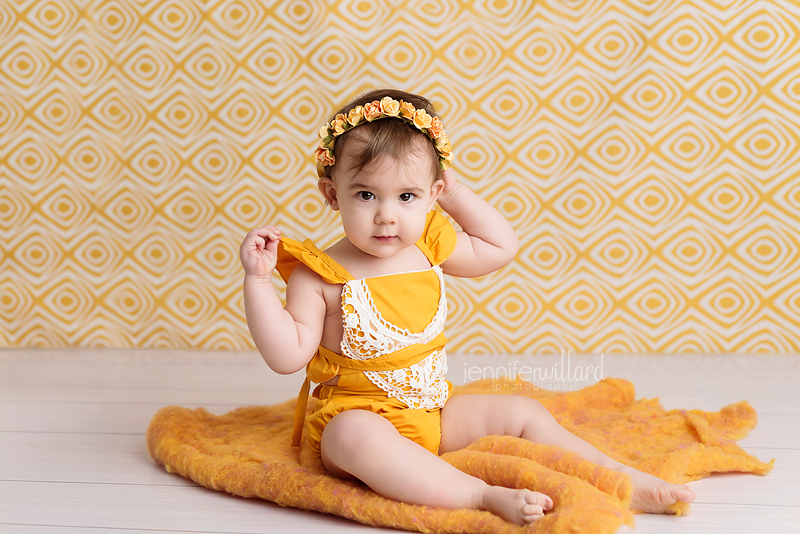 baby-girl-6-month-milestone-portrait-sitting-up-yellow-romper-flower-crown-spring-backdrop