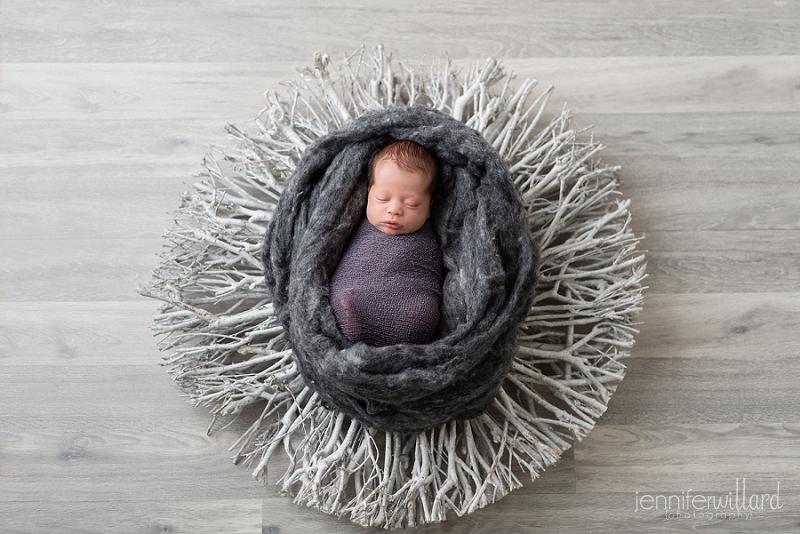 newborn-baby-boy-grey-wrap-white-nest-grey-wool-grey-wood-floor