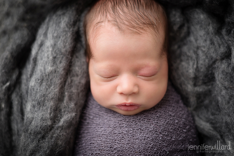 baby-boy-grey-wrap-close-up-portrait-studio-pose