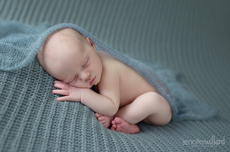 newborn-baby-girl-portrait-grey-blanket-studio