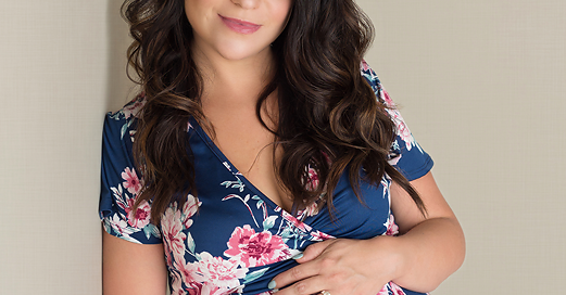 Beautiful Maternity Picture of Pregnant woman in blue flower dress in Jennifer Willard Photography studio in kingston ontario