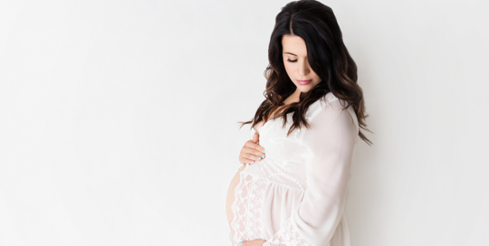 Maternity portrait of woman in lace robe in Kingston portrait studio