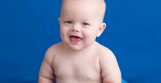 baby boy on blue backdrop in black round crate in kingston ontario studio