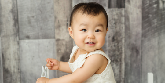 baby girl on grey backdrop in kingston ontario studio