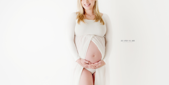 beautiful pregnant woman in white dress in studio on white backdrop in Kingston Ontario Photography Studio