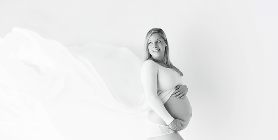 maternity dress with white tossing train picture in Kingston portrait studio