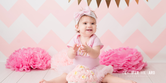 pink and gold cake smash picture in kingston portrait studio with baby girl