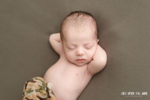 baby boy in army camo pants on green grey blanket in kingston photography studio