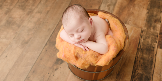 baby boy in wood bucket with mustard yellow felt in kingston ontario newborn studio