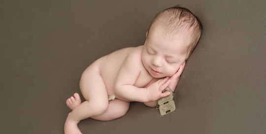 baby boy on green grey blanket with military army tags from father at RMC in kingston ontario portrait studio