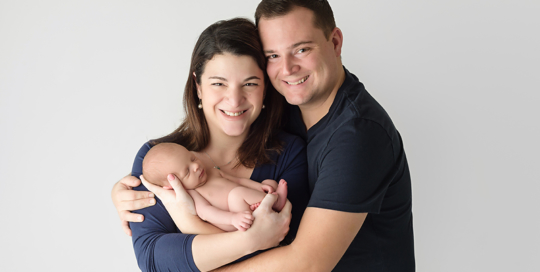 baby boy with parents in kingston newborn photography studio