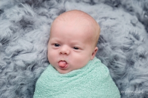 newborn baby boy blue wrap grey floakti rug tongue out kingston newborn photographer