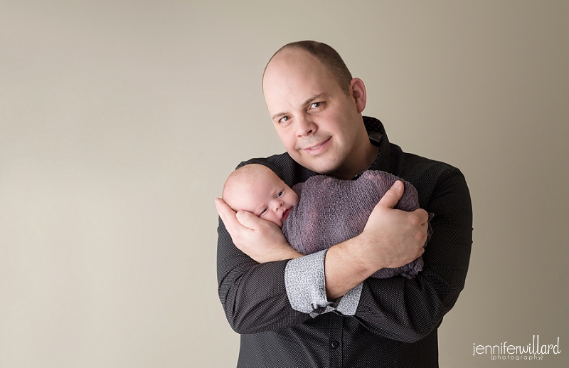 newborn baby boy grey romper dad beige wall Jennifer Willard Photography Kingston