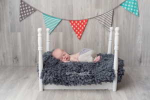 newborn baby boy white bed grey blue orange banner Kingston newborn photographer