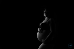 black and white picture of pregnant mother in bra and underwear by Kingston Maternity Photographer