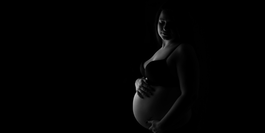 black and white picture of pregnant mother in bra and underwear by Kingston Maternity Photographer