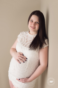 Expecting Mother in white crochet dress by Kingston Photographer