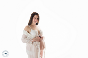 Pregnant Mom in white robe by Kingston Maternity Photographer