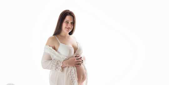 Pregnant Mom in white robe by Kingston Maternity Photographer