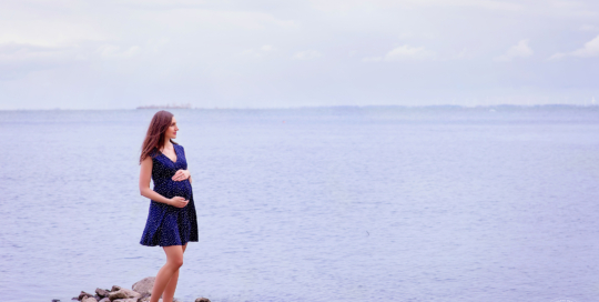 Pregnant woman waterside lake portrait Kingston Maternity Photographer