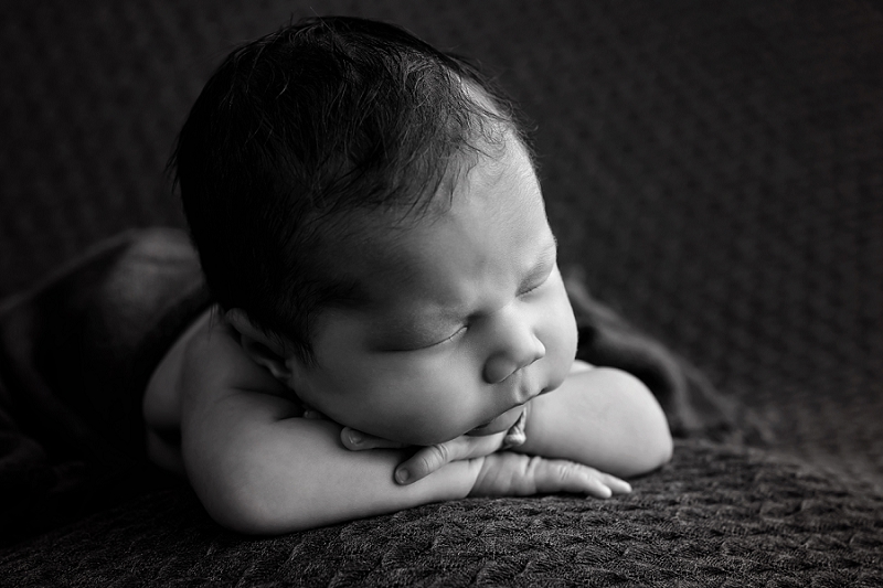 newborn baby boy head on hands in black and white by Belleville Newborn Photographer