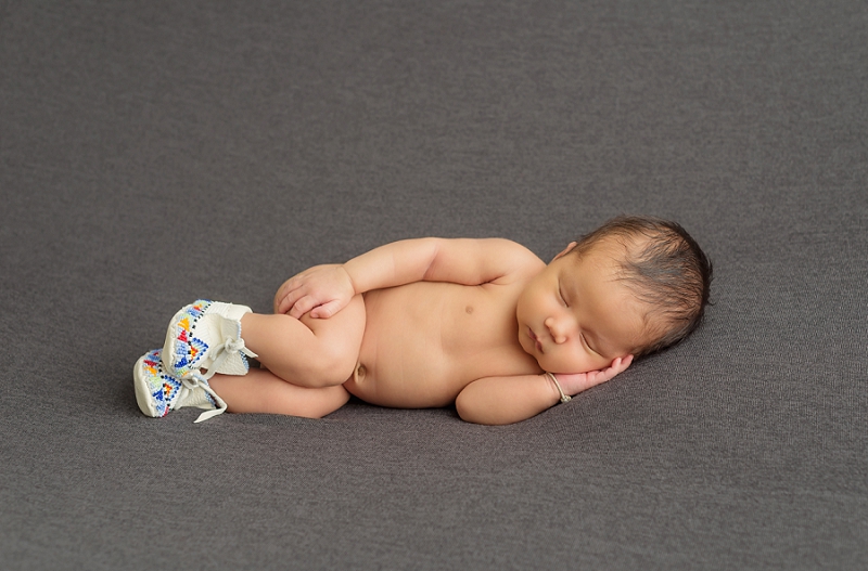 newborn baby boy with feet in handmade mocassins on grey blanket by Belleville Newborn Photographer