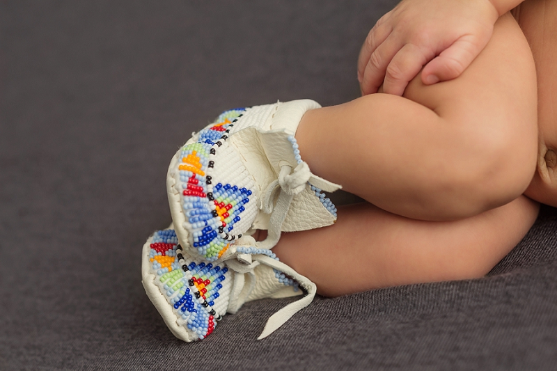 newborn baby feet in handmade mocassins on grey blanket by Belleville Newborn Photographer